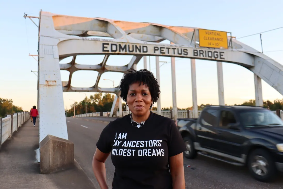 Woman standing in front of Edmund Pettus Bridge